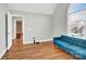 Bright living room featuring hardwood floors, a blue sofa, and a large window at 2275 Laurens Dr, Concord, NC 28027