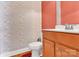 Charming powder room featuring floral wallpaper, hardwood floors, and vanity with framed mirror at 2275 Laurens Dr, Concord, NC 28027