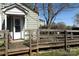 Close-up of the charming cottage-style home with a wooden porch, accessible ramp, and easy access to the front door at 2547 Gastonia Hwy, Lincolnton, NC 28092