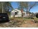 Charming cottage-style home with a wooden porch and easy access ramp surrounded by mature trees and natural landscape at 2547 Gastonia Hwy, Lincolnton, NC 28092