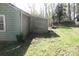 Exterior view showing the side of the house with siding and the edge of a grassy, tree-filled yard at 2547 Gastonia Hwy, Lincolnton, NC 28092