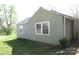 Cottage-style house exterior featuring siding and windows, set in a grassy yard with mature trees at 2547 Gastonia Hwy, Lincolnton, NC 28092