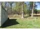 Side of a house with a grassy yard and mature trees, suggesting a peaceful and private setting at 2547 Gastonia Hwy, Lincolnton, NC 28092