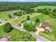 Birds-eye view of a home with an expansive yard, pool, and outbuildings, surrounded by trees at 2614 Reepsville Rd, Lincolnton, NC 28092