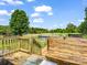 Inviting backyard featuring a wooden deck, above-ground pool, and sprawling lawn at 2614 Reepsville Rd, Lincolnton, NC 28092