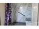 Bathroom features white marble-look shower with shelves and purple curtain at 2614 Reepsville Rd, Lincolnton, NC 28092