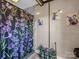 Bathroom features shower with purple floral curtain and kitty art at 2614 Reepsville Rd, Lincolnton, NC 28092