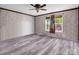 Well-lit bedroom with a ceiling fan, wood-look flooring, and a window with nature views at 2614 Reepsville Rd, Lincolnton, NC 28092