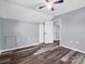 Bright bedroom featuring light blue walls, ceiling fan, closet and hard surface floors at 2614 Reepsville Rd, Lincolnton, NC 28092