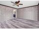 Bright bedroom with gray wood-look floors and ceiling fan at 2614 Reepsville Rd, Lincolnton, NC 28092
