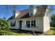 Charming home exterior with dormer windows, black shutters, and well-maintained landscaping at 2614 Reepsville Rd, Lincolnton, NC 28092