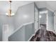 Hallway featuring light blue walls, chandelier and hard surface floors at 2614 Reepsville Rd, Lincolnton, NC 28092