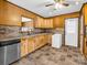 Bright kitchen with wood cabinets, tile flooring, and a door to the outside at 2614 Reepsville Rd, Lincolnton, NC 28092