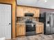 View of kitchen featuring wood cabinets and black stainless steel appliances at 2614 Reepsville Rd, Lincolnton, NC 28092
