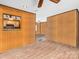 View of the living room space showing paneled walls, unique flooring, and ceiling fan at 2614 Reepsville Rd, Lincolnton, NC 28092