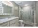 This bathroom features a granite countertop, a tiled shower and floors, and neutral wall paint at 2617 Brookwood Rd, Lincolnton, NC 28092