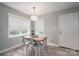 Charming dining area with a rustic table, modern lighting, and plenty of natural light at 2617 Brookwood Rd, Lincolnton, NC 28092