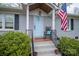 Charming home exterior with a light blue front door, American flag, and rocking chair at 2617 Brookwood Rd, Lincolnton, NC 28092