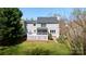 Expansive backyard featuring a deck and screened-in porch with ample green space and mature trees at 2815 Providence Spring Ln, Charlotte, NC 28270