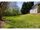 Large backyard offering plenty of space for outdoor activities with mature landscaping and a tree line at 2815 Providence Spring Ln, Charlotte, NC 28270