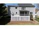 This home features a white fenced deck and covered screened-in porch, perfect for enjoying the outdoors at 2815 Providence Spring Ln, Charlotte, NC 28270