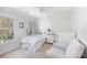 Bright bedroom with a comfy chair, two windows, and a decorative lamp at 2815 Providence Spring Ln, Charlotte, NC 28270