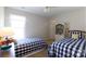Cozy bedroom featuring two twin beds, a window, and a bookcase at 2815 Providence Spring Ln, Charlotte, NC 28270