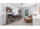 Bright home office with a window view, bookshelves, and a comfortable lounge chair at 2815 Providence Spring Ln, Charlotte, NC 28270