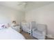 Bedroom featuring a white crib, a comfy chair, and a bright bedside lamp at 2815 Providence Spring Ln, Charlotte, NC 28270