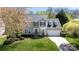 Beautiful two-story home boasts a well-maintained lawn, mature trees, and a side-entry garage at 2815 Providence Spring Ln, Charlotte, NC 28270