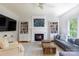 Relaxing living room featuring a fireplace, built-in bookshelves, and hardwood floors at 2815 Providence Spring Ln, Charlotte, NC 28270