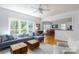 Comfortable living room is flooded with natural light and adjoins a dining room and kitchen at 2815 Providence Spring Ln, Charlotte, NC 28270