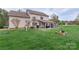 Sprawling backyard featuring well-manicured lawn, covered patio, and lush foliage at 301 Prairie Rose Ct, Waxhaw, NC 28173