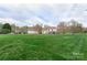 Expansive backyard featuring lush green grass and mature trees, perfect for outdoor activities at 301 Prairie Rose Ct, Waxhaw, NC 28173