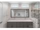 Modern bathroom featuring a double vanity with granite countertop and a tiled shower at 301 Prairie Rose Ct, Waxhaw, NC 28173
