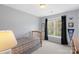 Bright bedroom with a single bed, large window with natural light, and neutral-colored walls at 301 Prairie Rose Ct, Waxhaw, NC 28173