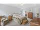 Charming bedroom with tray ceiling, carpet and a comfortable queen-sized bed with a quilt at 301 Prairie Rose Ct, Waxhaw, NC 28173