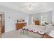 Bright bedroom with tray ceiling, carpet, and dressers with windows offering natural light at 301 Prairie Rose Ct, Waxhaw, NC 28173