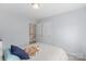 Bedroom with light blue walls, plush carpet, and a glimpse of the staircase and landing at 301 Prairie Rose Ct, Waxhaw, NC 28173