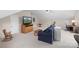Spacious bonus room with carpet, ceiling fan, couch, television and desk with chair at 301 Prairie Rose Ct, Waxhaw, NC 28173