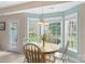 Bright breakfast nook with large bay windows, tile floors, and a round dining table with seating at 301 Prairie Rose Ct, Waxhaw, NC 28173