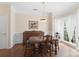 Formal dining room with hardwood floors, wainscoting, and a large window providing ample natural light at 301 Prairie Rose Ct, Waxhaw, NC 28173