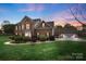 Beautiful two-story brick home boasts manicured lawn, mature landscaping, and a detached two-car garage at 301 Prairie Rose Ct, Waxhaw, NC 28173