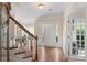 Spacious foyer with hardwood floors and staircase, bathed in natural light, offers a welcoming entrance at 301 Prairie Rose Ct, Waxhaw, NC 28173