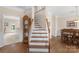 Inviting foyer showcases hardwood floors, staircase with wood handrail, and a glimpse of the adjacent dining room at 301 Prairie Rose Ct, Waxhaw, NC 28173