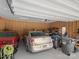 Spacious garage interior with multiple cars, ample storage, and overhead lighting at 301 Prairie Rose Ct, Waxhaw, NC 28173
