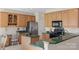 Well-lit kitchen features oak cabinets, granite countertops, stainless steel appliances, and a breakfast bar at 301 Prairie Rose Ct, Waxhaw, NC 28173