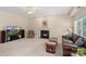 Inviting living room with fireplace, entertainment center and comfortable seating arrangement for relaxation and entertainment at 301 Prairie Rose Ct, Waxhaw, NC 28173