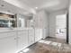 Bathroom with double vanity, tile floor, large mirror, and walk-in shower with glass door at 3036 Whipcord Dr, Waxhaw, NC 28173