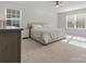 Bright bedroom featuring neutral decor, a ceiling fan, and large windows with plenty of natural light at 3036 Whipcord Dr, Waxhaw, NC 28173